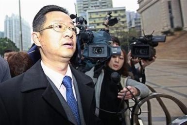 Xie Xianghui, a lawyer representing Proview Technology (Shenzhen) is surrounded by reporters as he walks into the Higher People&#039;s Court of Guangdong in Guangzhou, Guangdong province February 29, 2012.