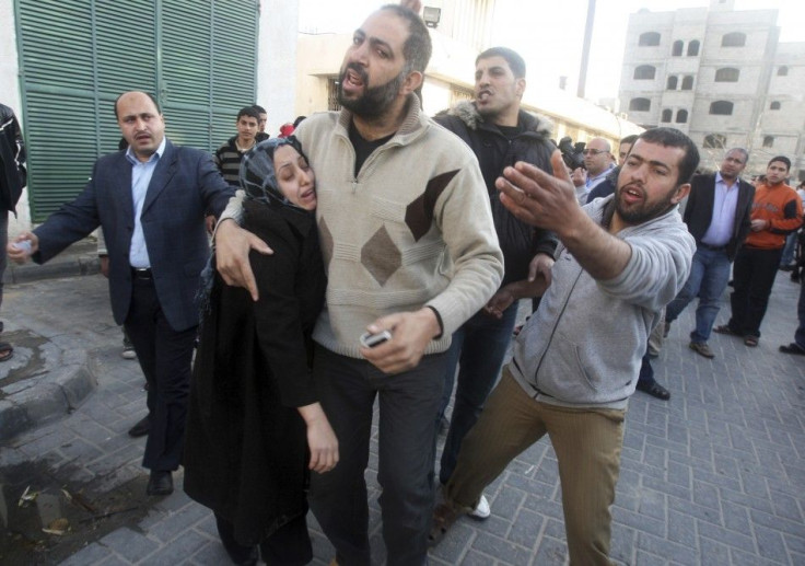 A Palestinian woman reacts at a hospital after an Israeli targeted attack on a car in Gaza City