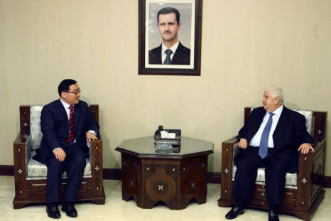 Syrian Foreign Minister Walid al-Moualem meets the Chinese envoy to Syria Li Huaxin in Damascus.