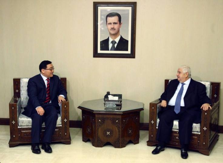 Syrian Foreign Minister Walid al-Moualem meets the Chinese envoy to Syria Li Huaxin in Damascus.