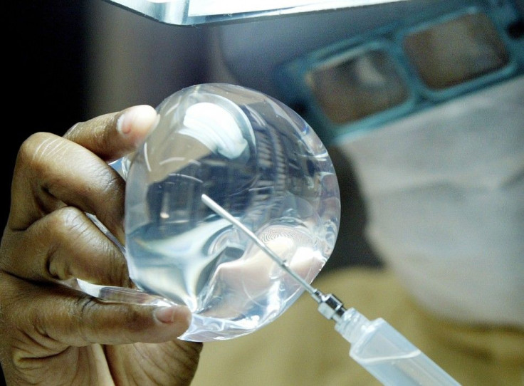 A laboratory worker of Silimed factory checks silicone in Rio de Janeiro, in this picture taken on March 27, 2003.