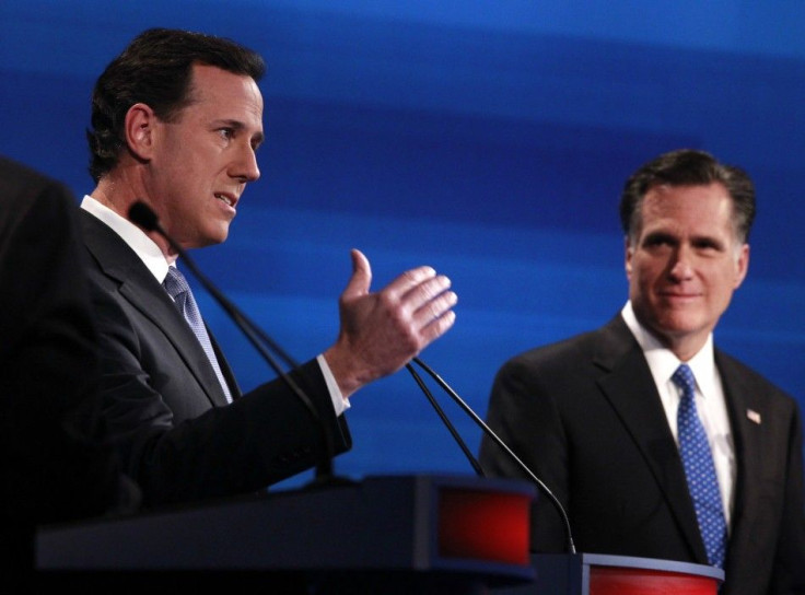 Republican presidential candidate former U.S. Senator Rick Santorum (R-PA) speaks as former Massachusetts Governor Mitt Romney (R) listens during the Republican presidential candidates debate in Myrtle Beach, South Carolina, January 16, 2012.