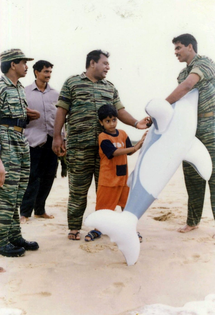 Undated picture given by Sri Lankan Ministry of Defence shows LTTE leader Prabhakaran playing with his son