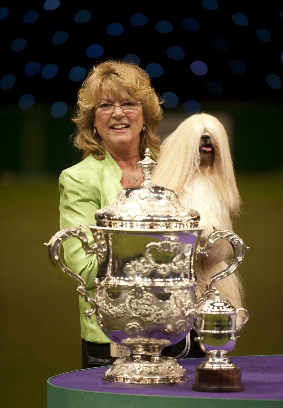  Owner Margaret Anderson celebrates with Elizabeth, a Lhasa Apso, after winning Best in Show on the final day of the Crufts dog show at the NEC arena in Birmingham