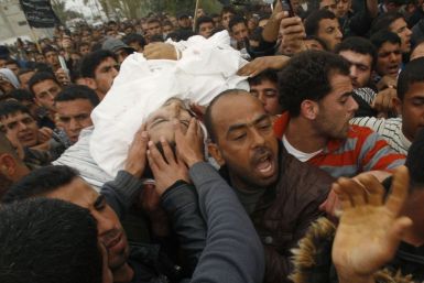 Palestinians carry the body of militant Abu Metlak during his funeral in Khan Younis