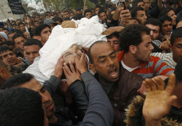 Palestinians carry the body of militant Abu Metlak during his funeral in Khan Younis