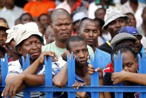 Mine workers listen to Zwelinzima Vavi, COSATU General Secretary, during his address at the Impala Platinum mine in Rustenburg