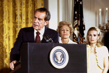 FILE PHOTO 9AUG74 - U.S. President Richard Nixon (L), listened to by First lady Pat Nixon and daught..