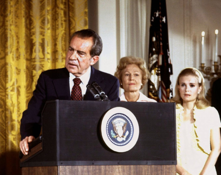 FILE PHOTO 9AUG74 - U.S. President Richard Nixon (L), listened to by First lady Pat Nixon and daught..