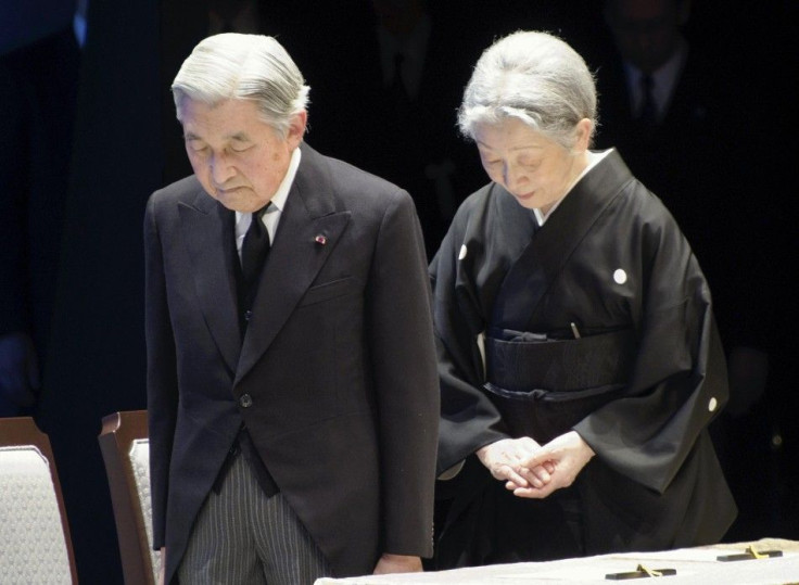 Japanese Emperor Akihito and Empress Michiko, bow during the national memorial service for tsunami and earthquake victims in Tokyo
