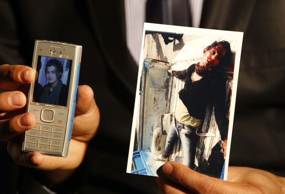 A gay activist known by his pseudonym Roby Hurriya shows pictures of his friend Saif Asmar before and after Asmar was killed during an interview with Reuters in Baghdad