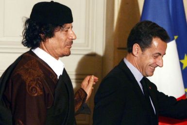 France's President Nicolas Sarkozy and Libyan leader Muammar Gaddafi leave the room after the signature of trade contracts in Paris in Dec. 2007.