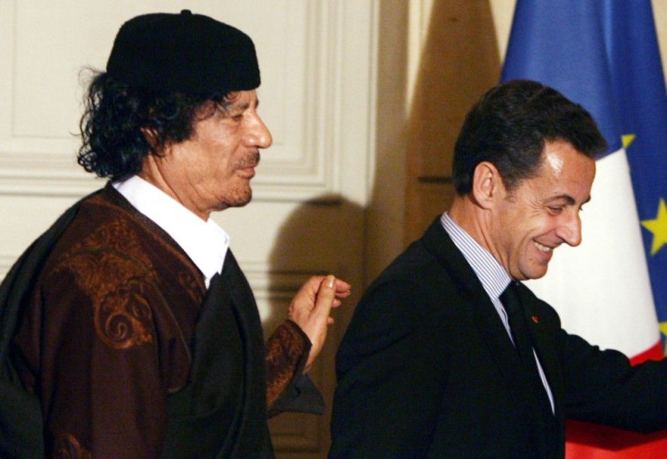 France's President Nicolas Sarkozy and Libyan leader Muammar Gaddafi leave the room after the signature of trade contracts in Paris in Dec. 2007.