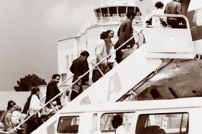 Asian immigrants boarding plane at Entebbe Airport, Uganda, 1972.