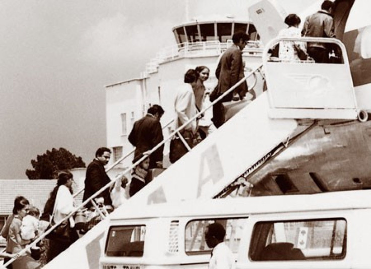 Asian immigrants boarding plane at Entebbe Airport, Uganda, 1972.