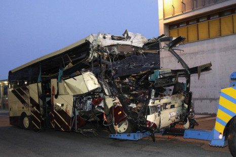 The wreckage of a bus that crashed into a motorway tunnel is pulled in Sierre, western Switzerland