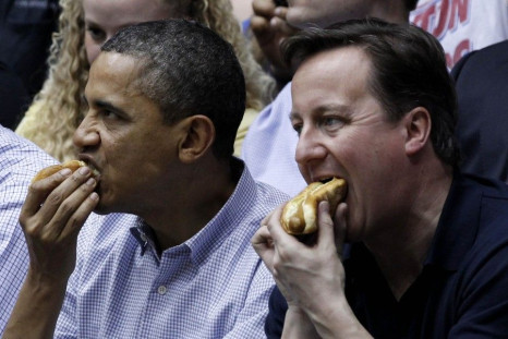 U.S. President Barack Obama and British Prime Minister David Cameron eat hot dogs