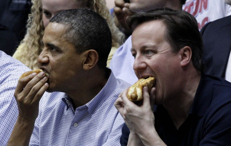 U.S. President Barack Obama and British Prime Minister David Cameron eat hot dogs