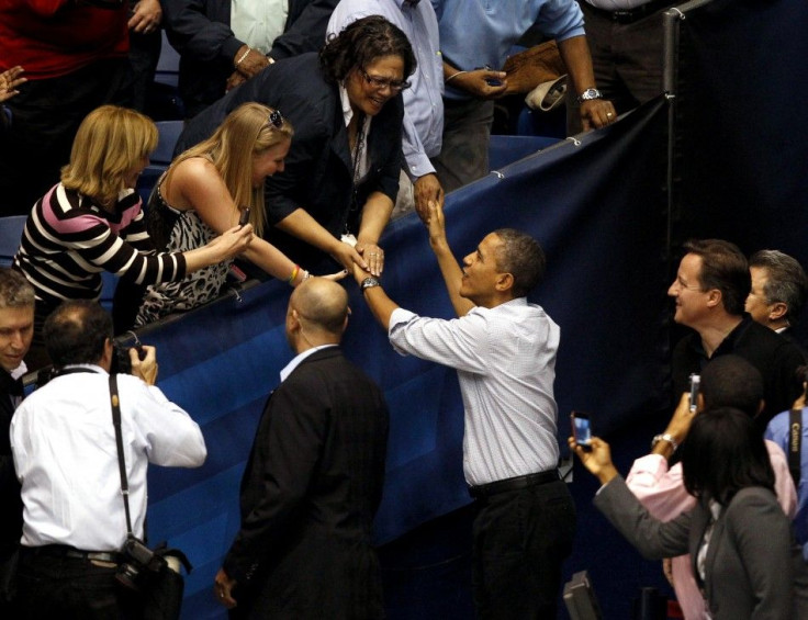 U.S. President Barack Obama greets supporters as he arrives with British PM David Cameron