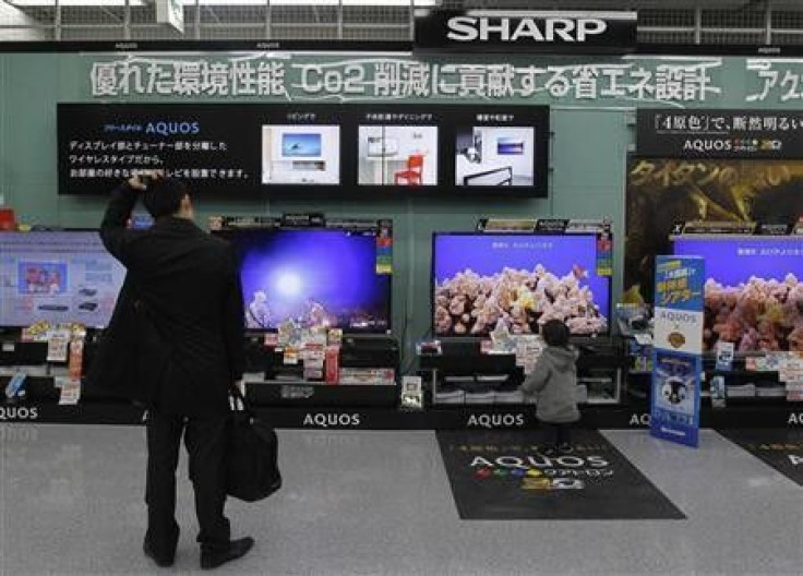 A man looks around Sharp's TV sets at an electronics store in Tokyo February 1, 2012.