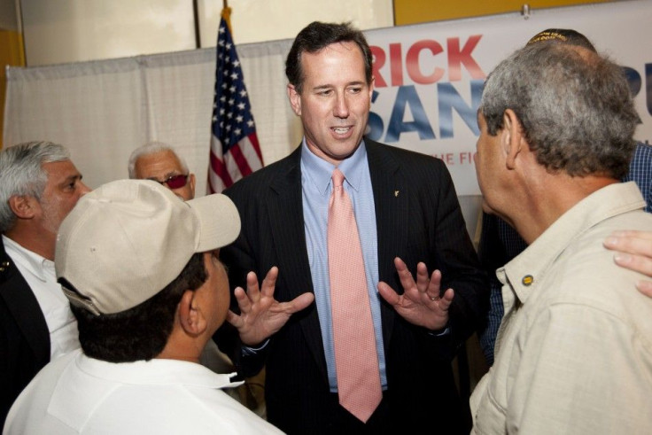 U.S. Republican presidential candidate and former Senator Rick Santorum is surrounded by veterans after his speech in a town hall meeting in San Juan.