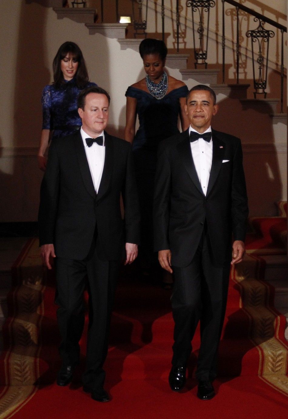 U.S. President Barack Obama front R and and first lady Michelle back R welcome British Prime Minister David Cameron and his wife Samantha to the White House for the State Dinner in Washington March 14, 2012.