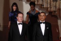 U.S. President Barack Obama (front R) and and first lady Michelle (back R) welcome British Prime Minister David Cameron and his wife Samantha to the White House for the State Dinner in Washington March 14, 2012.