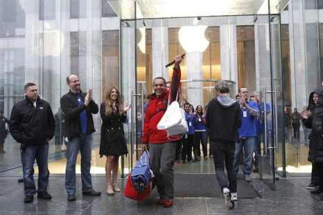 A man raises Apple's new iPad after purchasing it in New York