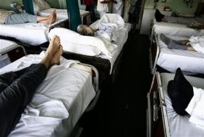 People are seen on beds in a room at the National Cancer Research Center within the Institute for Oncology and Radiology in Belgrade, October 6, 2009.