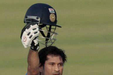 India's Sachin Tendulkar celebrates after he scored his 100th international century during their Asia Cup one- day international (ODI) cricket match against Bangladesh in Dhaka March 16, 2012. 