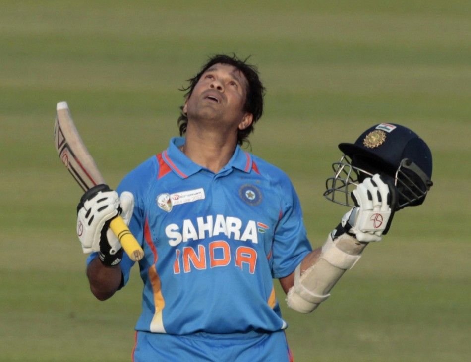 Indias Sachin Tendulkar celebrates after he scored his 100th international centuries during their Asia Cup One Day International ODI cricket match against Bangladesh in Dhaka March 16, 2012.