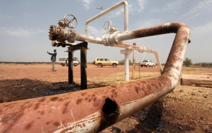 Oil spills onto the ground from an oil well head strafed by shrapnel from a bomb dropped by fighter jets at the El Nar oil field in South Sudan's Unity State