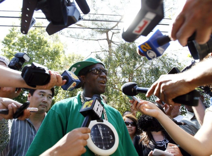 Rapper Flavor Flav is interviewed outside the Jackson family home in Encino