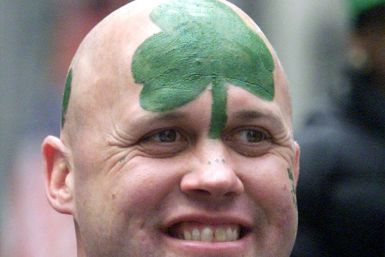 MAN WITH PAINTED HEAD WATCHES SAINT PATRICK'S DAY PARADE IN NEW YORK.
