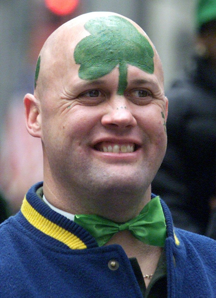 MAN WITH PAINTED HEAD WATCHES SAINT PATRICK'S DAY PARADE IN NEW YORK.