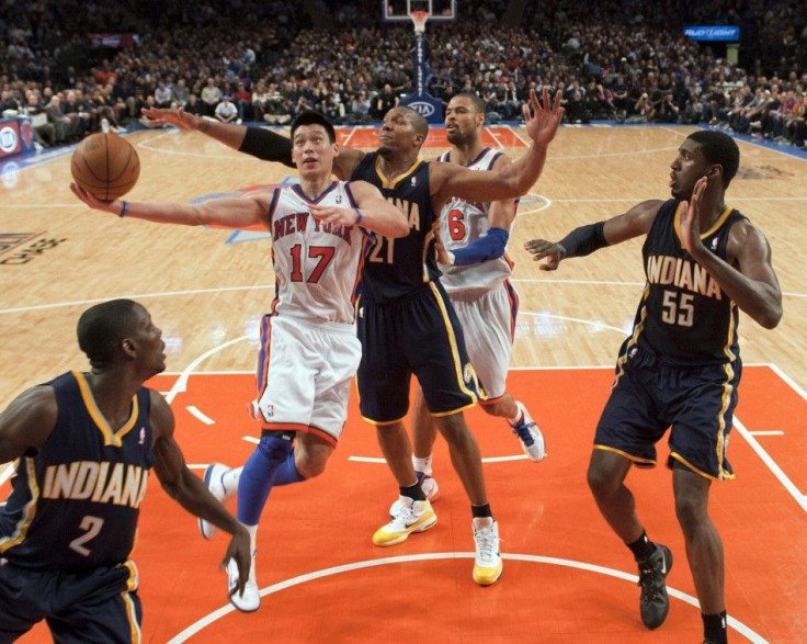New York Knicks guard Jeremy Lin (17) drives past Indiana Pacers forward David West (21), guard Darren Collison (2) and center Roy Hibbert (55) in the third quarter of their NBA basketball game at Madison Square Garden in New York March 16, 2012.