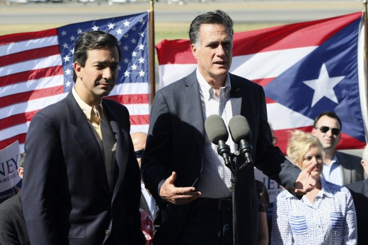 Mitt Romney addresses media next to Puerto Rico Gov. Luis Fortuño upon arrival at Isla Grande airport in San Juan March 16, 2012.