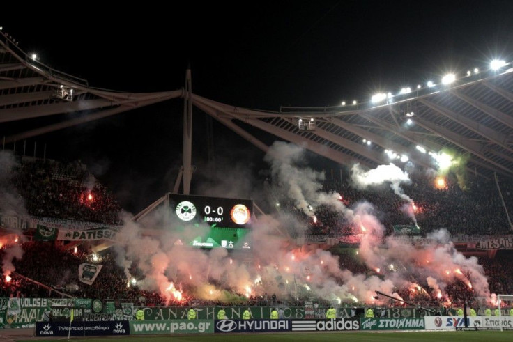 The Greece League game between Panathinaikos and Olympiakos was abandoned after fans set fire to parts of the stadium.