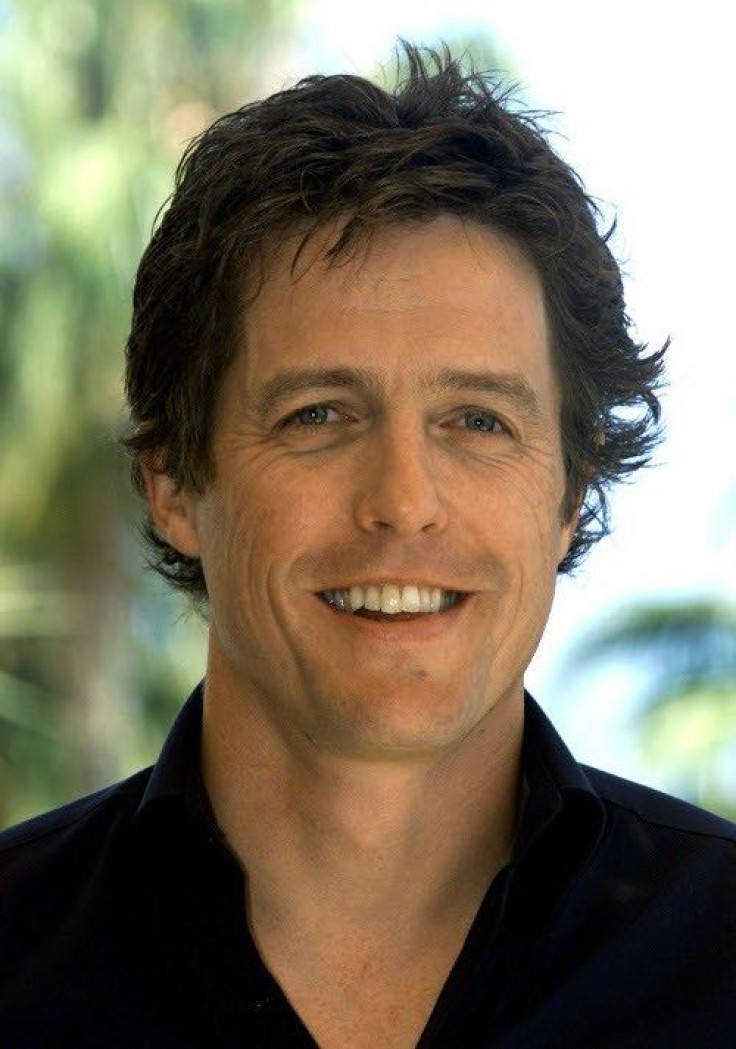 British actor Hugh Grant poses for photographers during a photocall in Cannes May 25, 2002. 