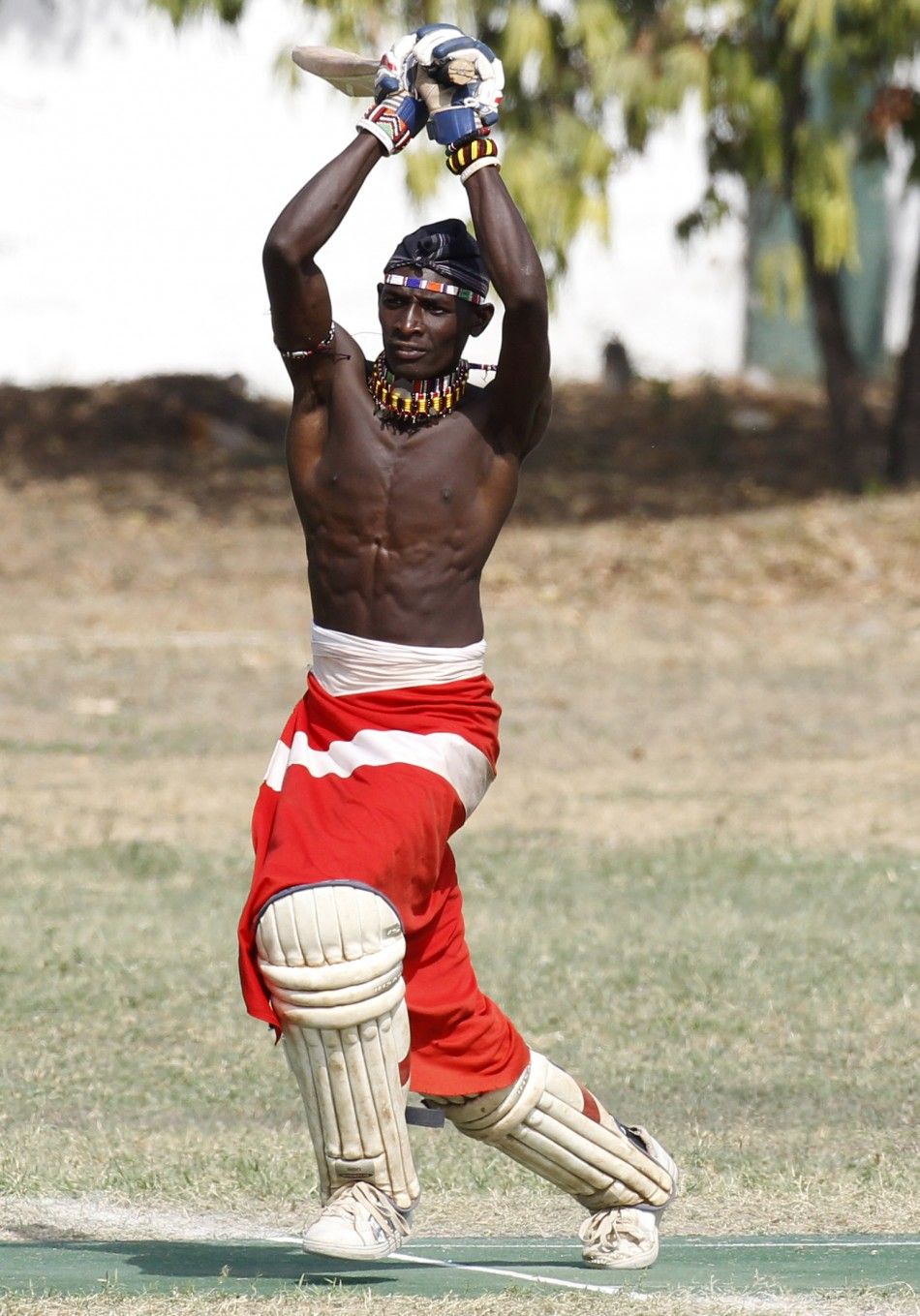 Olengais, captain of the Maasai Cricket Warriors, plays a shot during their friendly match in Mombasa