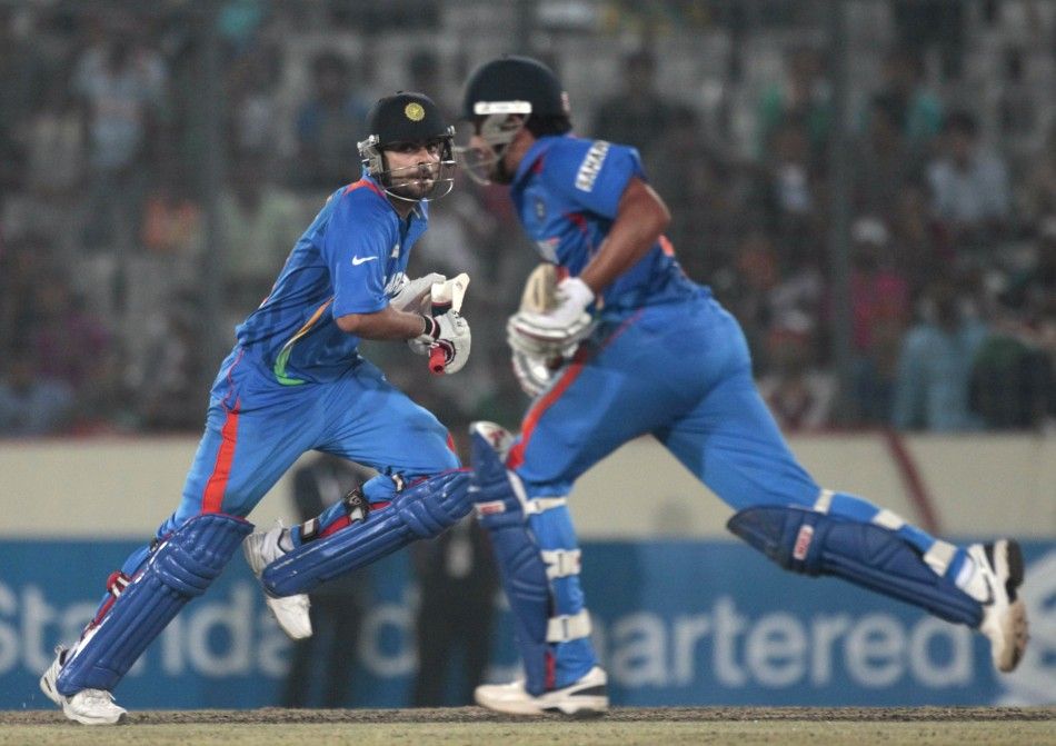  Indias Dhoni and Kohli run between the wickets against Pakistan during their Asia Cup One Day International cricket match in Dhaka