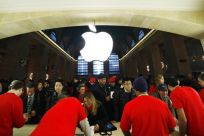 Customers buy Apple products inside the newest Apple Store during its opening on the East Balcony in the main lobby of New York City's Grand Central Station