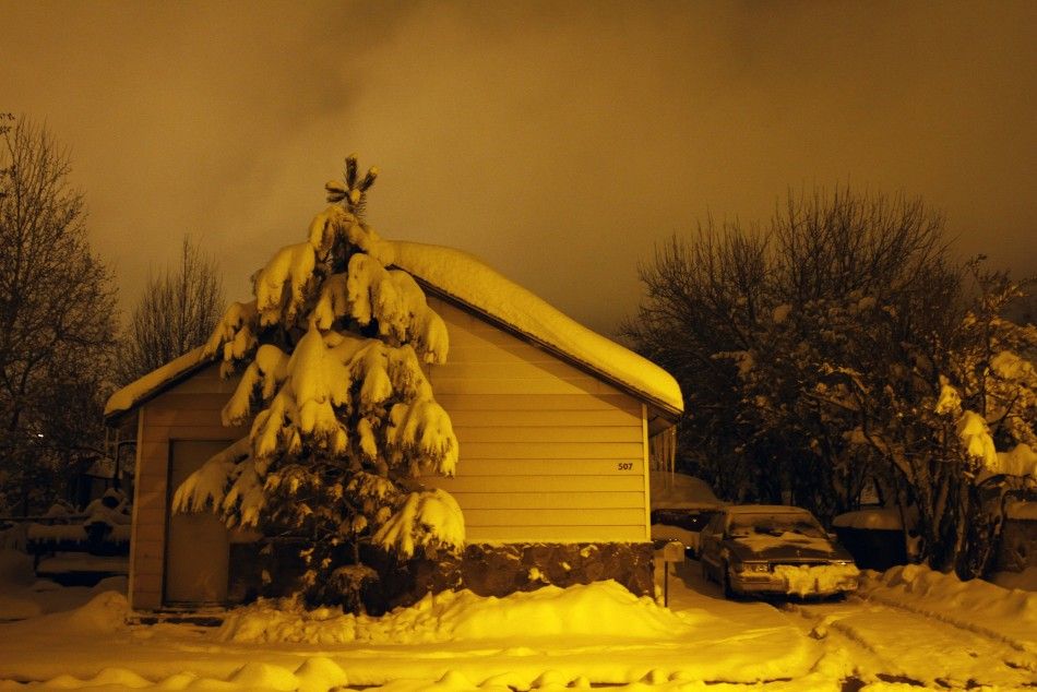 Several inches of snow cover a house and its surroundings in Flagstaff, Arizona, March 18, 2012. The late winter storm kept temperatures well below normal in California on Sunday and generated heavy snow fall in several states, including Arizona, where se