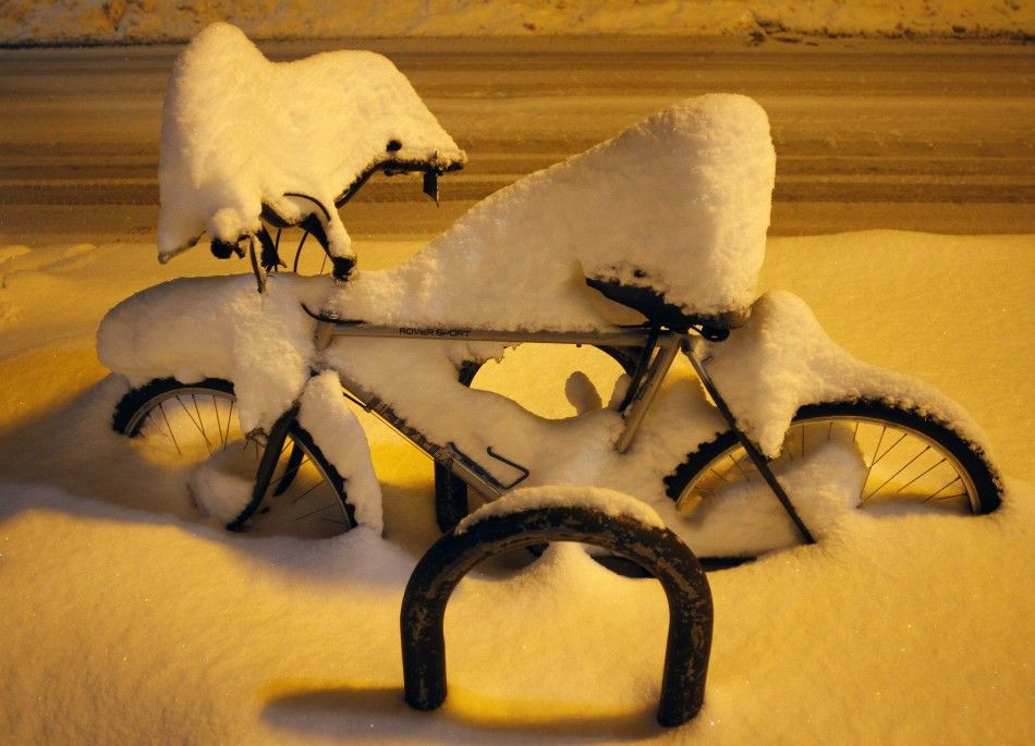 Several inches of snow cover a bicycle in Flagstaff, Arizona March18, 2012. The late winter storm kept temperatures well below normal in California on Sunday and generated heavy snow fall in several states, including Arizona, where several highways in the