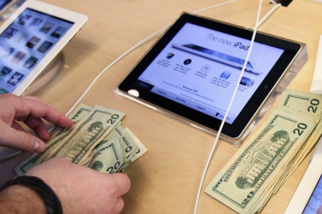An Apple employee counts money as a customer purchases Apple's new iPad at the 5th Avenue Apple Store in New York