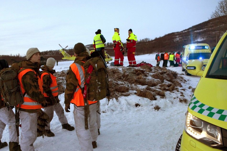Rescue personnel prepare to go to a mountain area where an avalanche is reported, in Kafjord