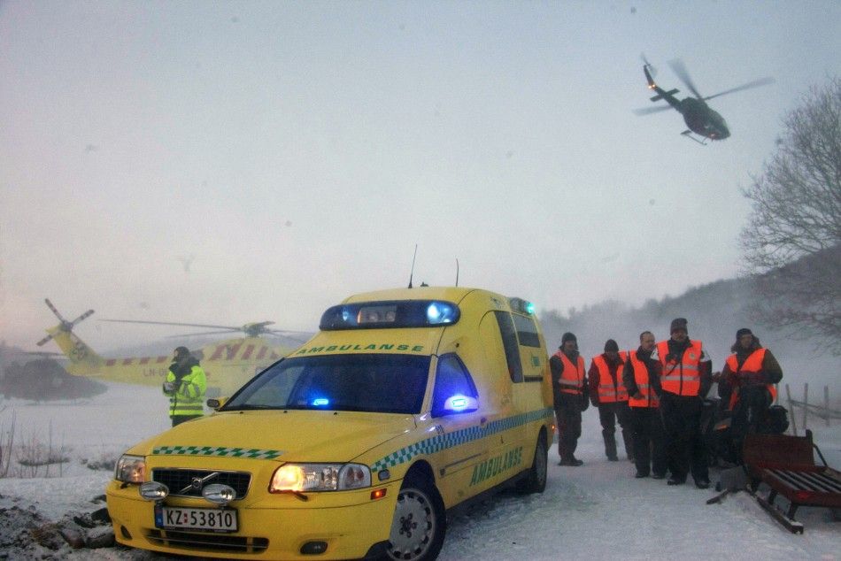 Rescue personnel prepare to go to a mountain area where an avalanche is reported, in Kafjord