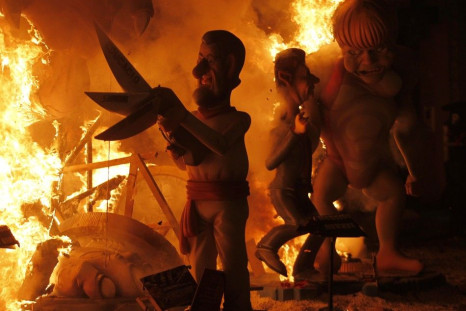 Effigies of Spain's Prime Minister Rajoy and German Chancellor Merkel burn during the finale of the Fallas festival in Valencia