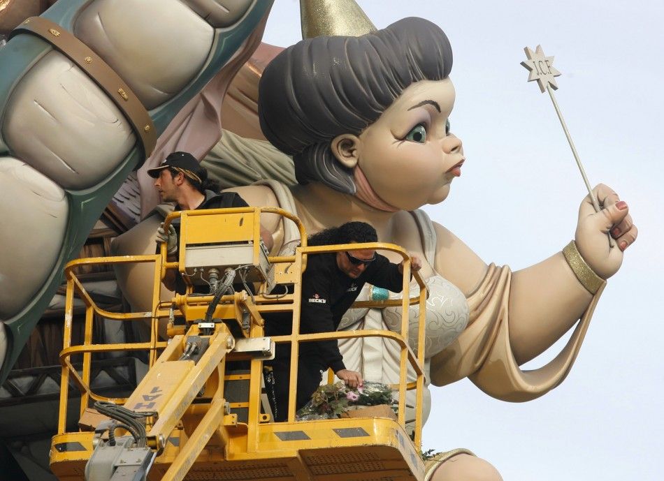Craftsmen add finishing touches to a figure during the last preparations ahead of the 039Fallas039 festival in Valencia