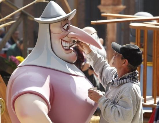 A craftsman puts the finishing touches on a giant figure ahead of the quotFallasquot festival in Valencia March 15, 2012